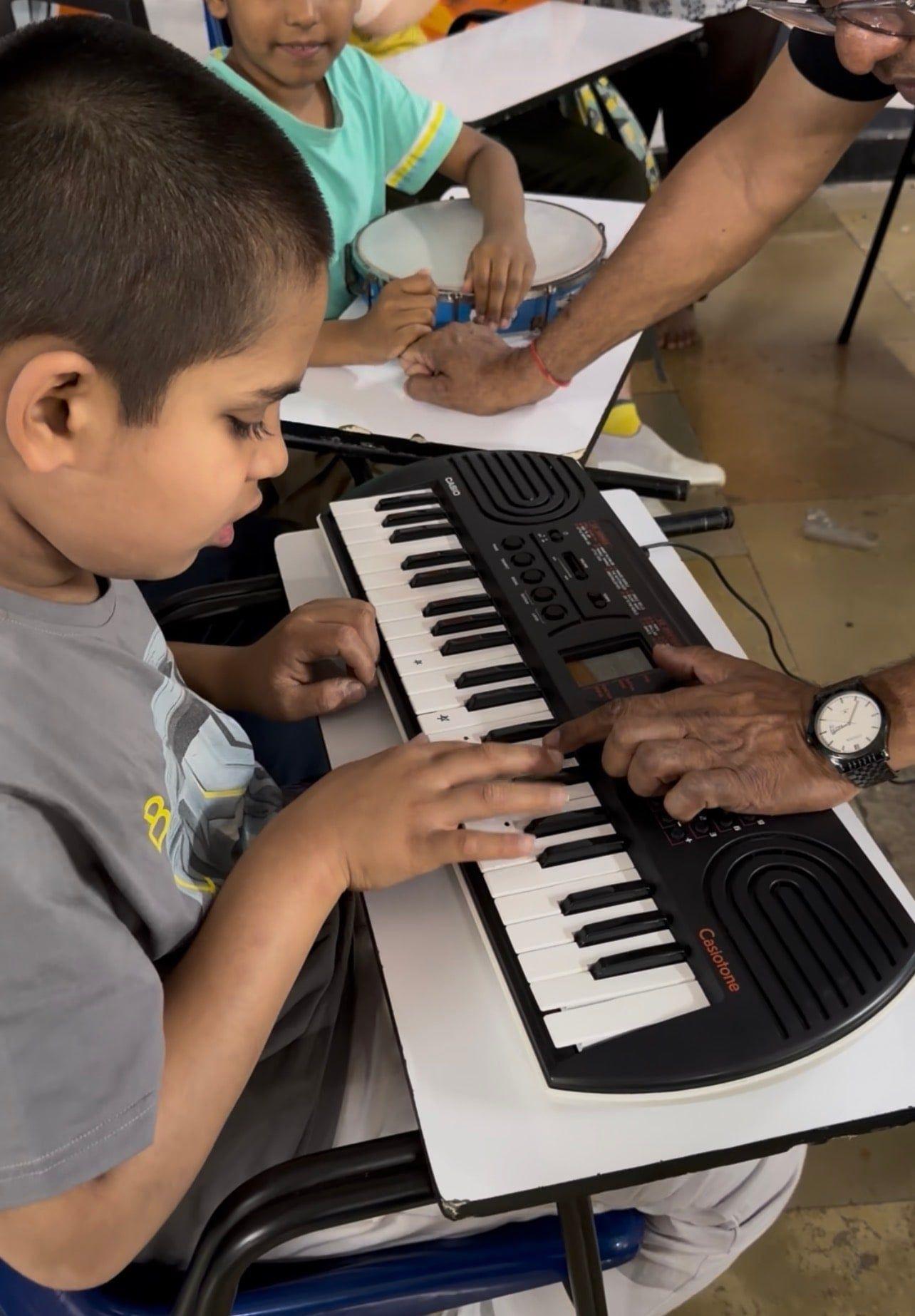 A young student playing an electronic keyboard